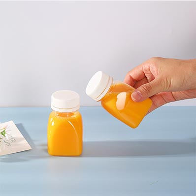 Wholesale price clear small 2oz plastic juice bottle with screw cap