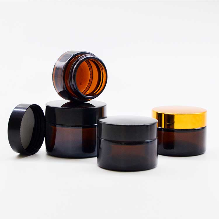 Wholesale 100ml amber glass cosmetic jars with black lids