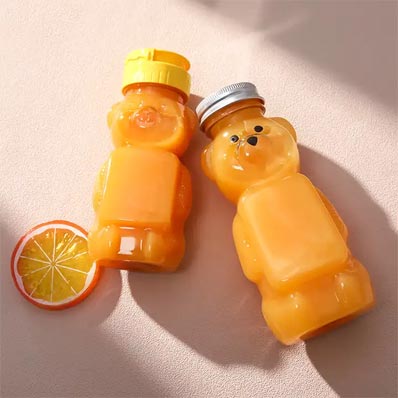 Wholesale custom size clear 250ml PET plastic bear juice bottles with caps