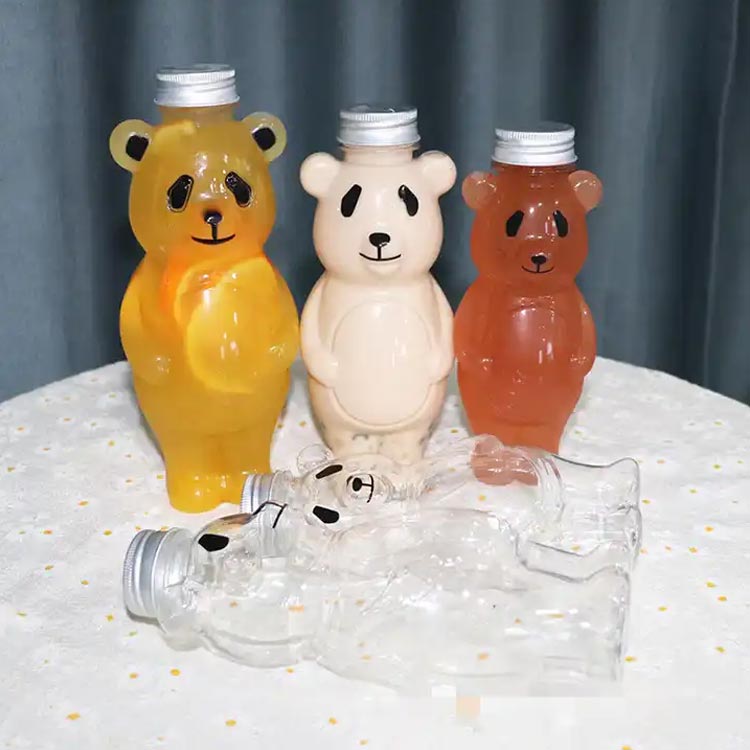 Bulk sale 700ml cartoon PET panada shape creative juice bottles with caps for juice/milk tea