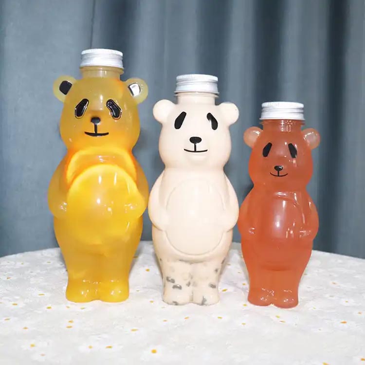 Bulk sale 700ml cartoon PET panada shape creative juice bottles with caps for juice/milk tea