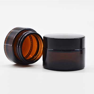 Wholesale 100ml amber glass cosmetic jars with black lids